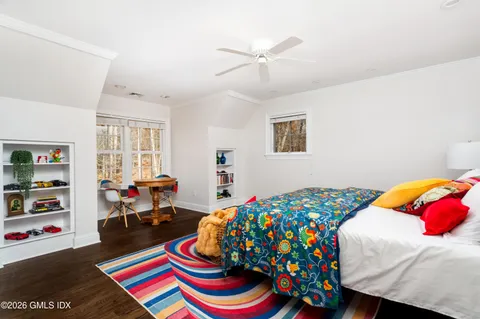 a bedroom with a bed and a table in it