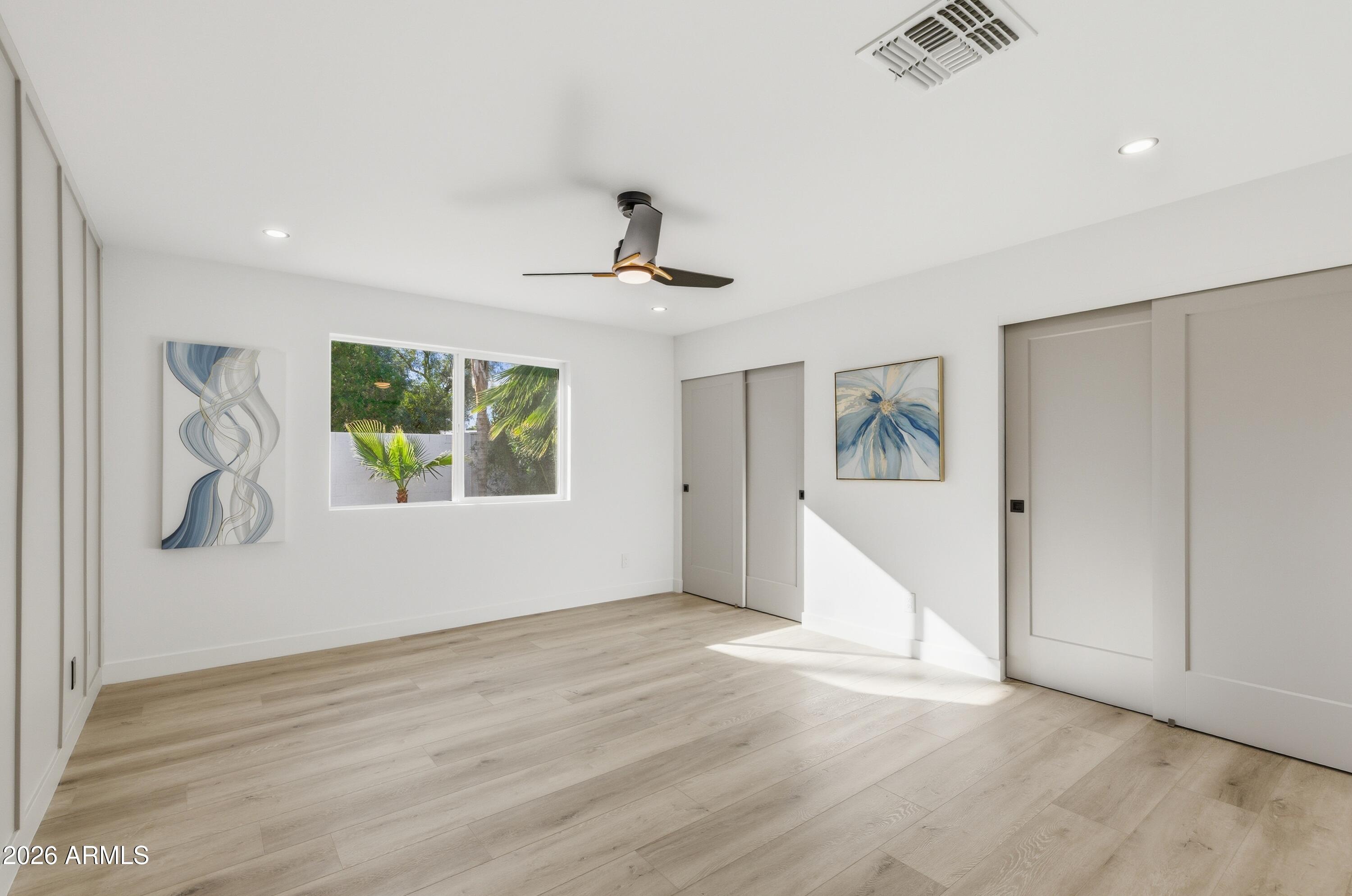 7761 East Chaparral Road Scottsdale, AZ 85250 - Photo 11 of 36 a view of an empty room with window and wooden floor