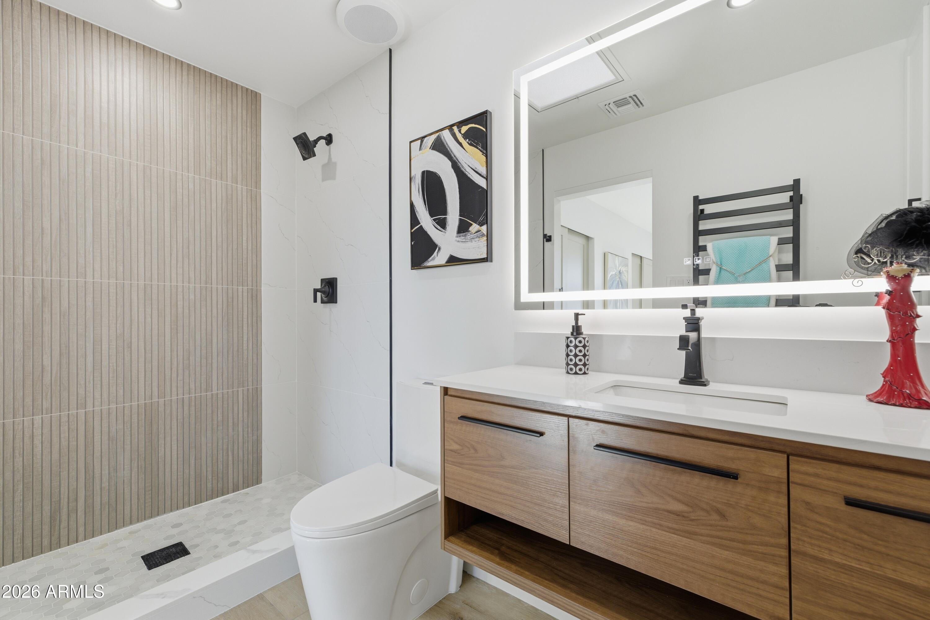7761 East Chaparral Road Scottsdale, AZ 85250 - Photo 13 of 36 a bathroom with a granite countertop sink toilet and shower