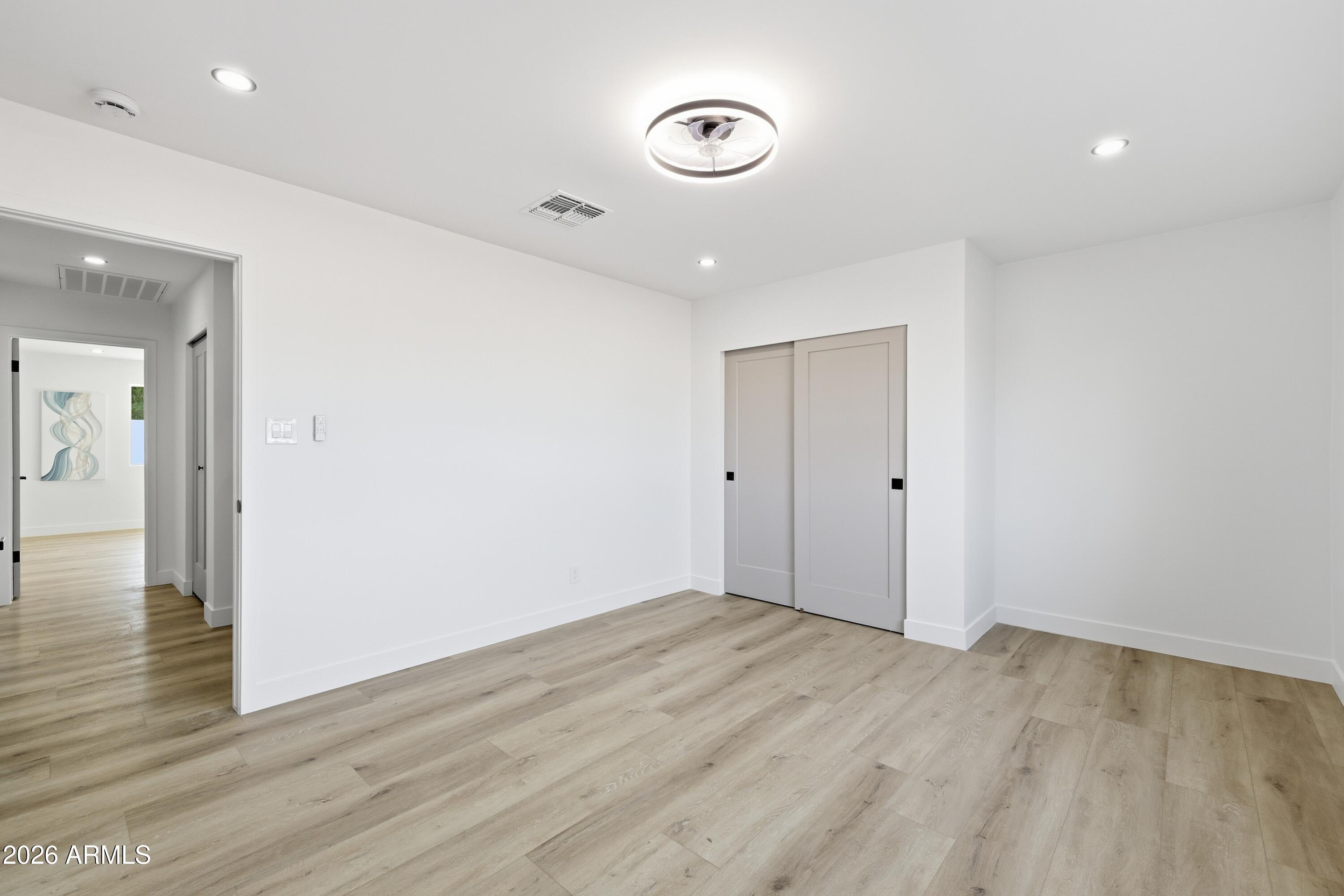 7761 East Chaparral Road Scottsdale, AZ 85250 - Photo 16 of 36 wooden floor in an empty room with a window