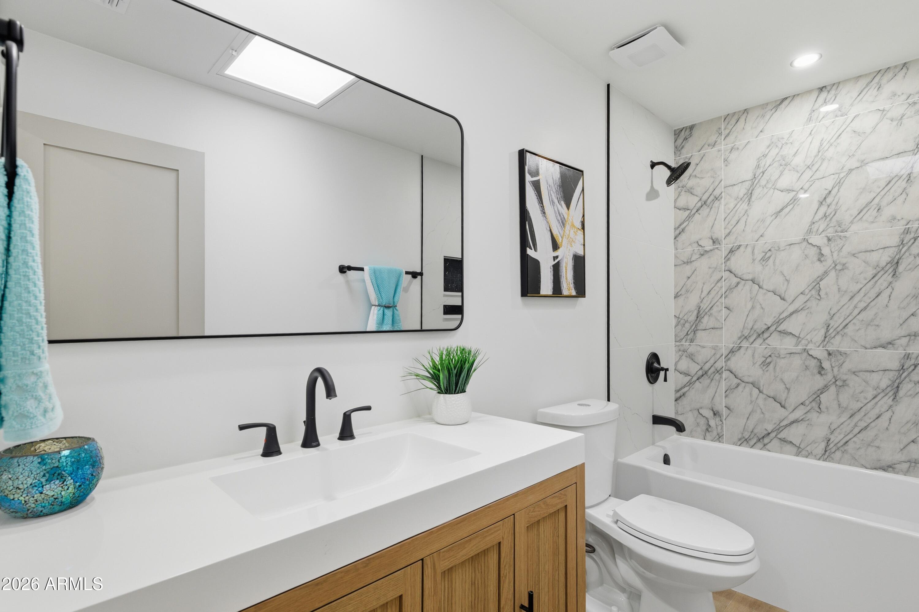7761 East Chaparral Road Scottsdale, AZ 85250 - Photo 17 of 36 a bathroom with a sink a toilet and shower