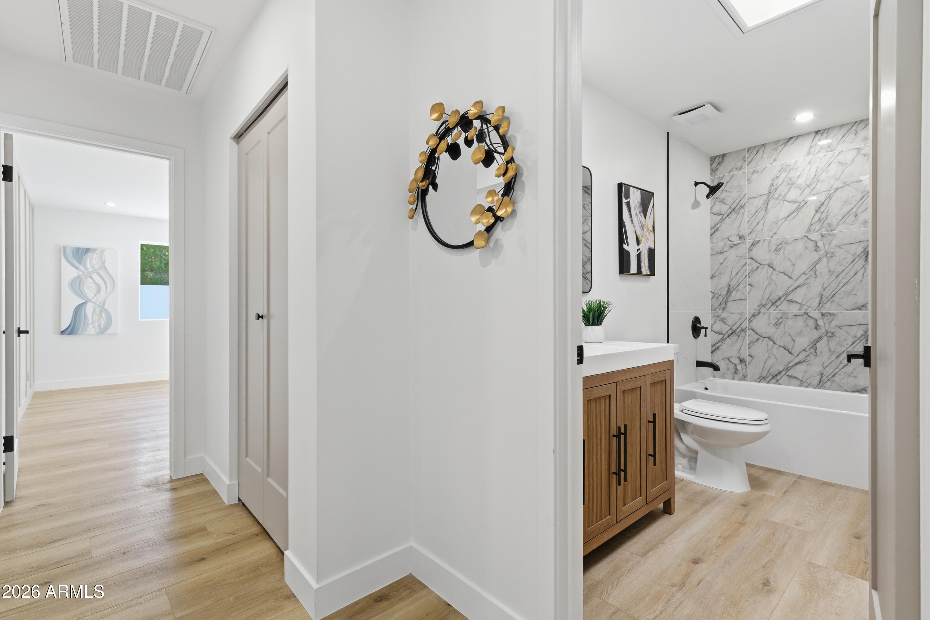 7761 East Chaparral Road Scottsdale, AZ 85250 - Photo 18 of 36 a bathroom with a toilet sink vanity granite and shower