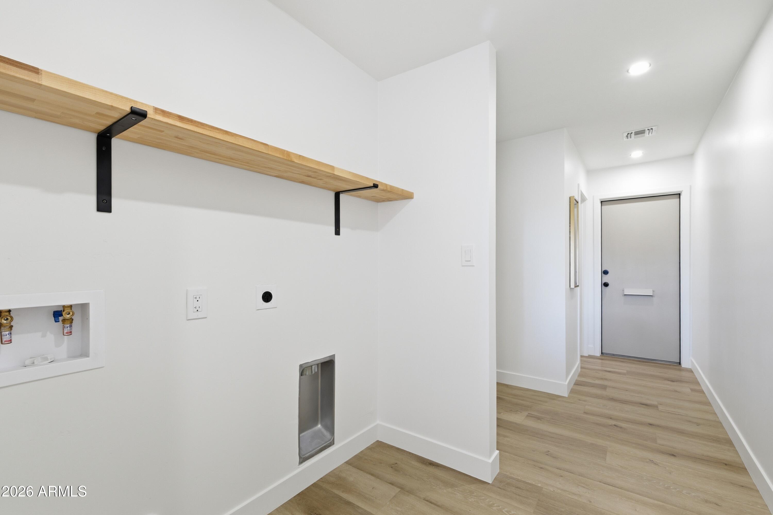 7761 East Chaparral Road Scottsdale, AZ 85250 - Photo 20 of 36 a view of a hallway with wooden floor