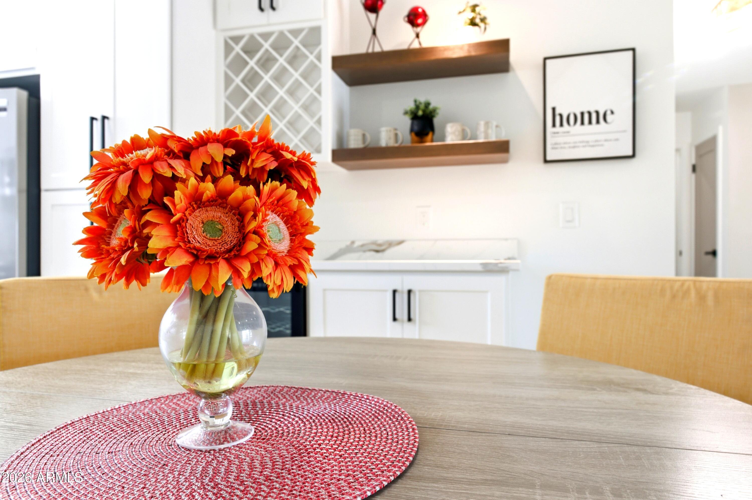 7761 East Chaparral Road Scottsdale, AZ 85250 - Photo 28 of 36 a vase of flowers sitting on a table with a fireplace