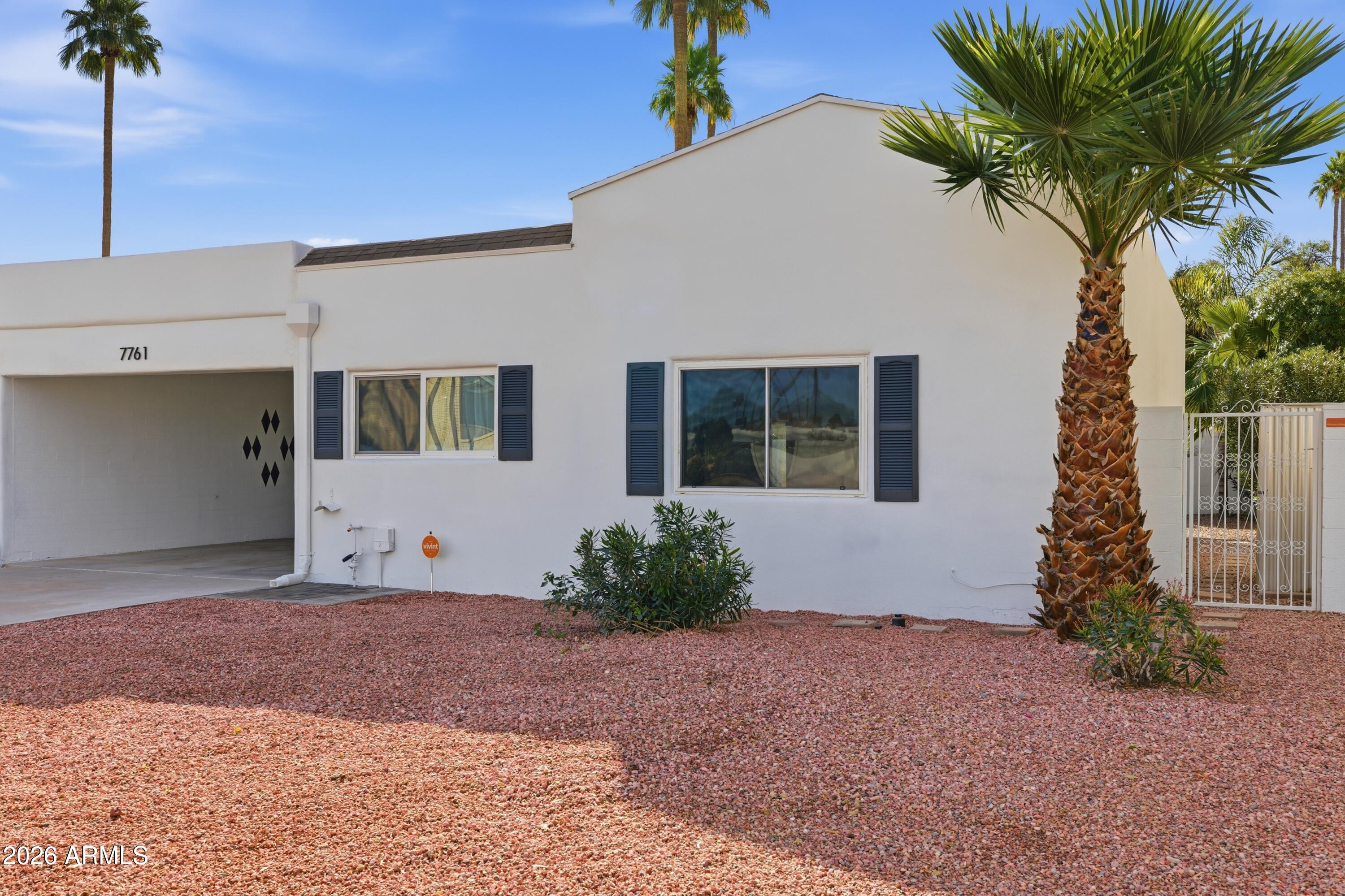 7761 East Chaparral Road Scottsdale, AZ 85250 - Photo 36 of 36 a front view of a house with garden