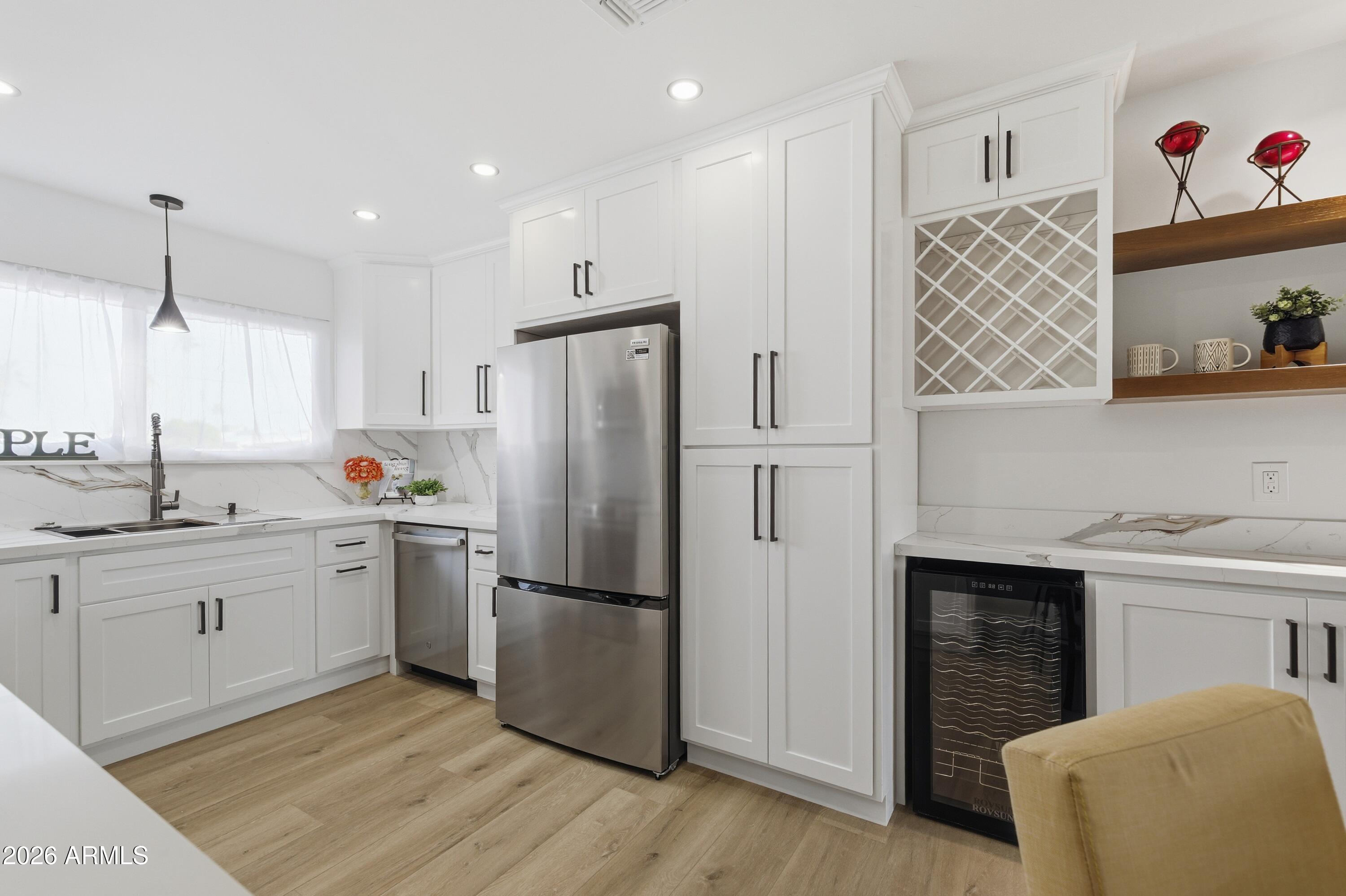7761 East Chaparral Road Scottsdale, AZ 85250 - Photo 4 of 36 a kitchen with a refrigerator and a sink