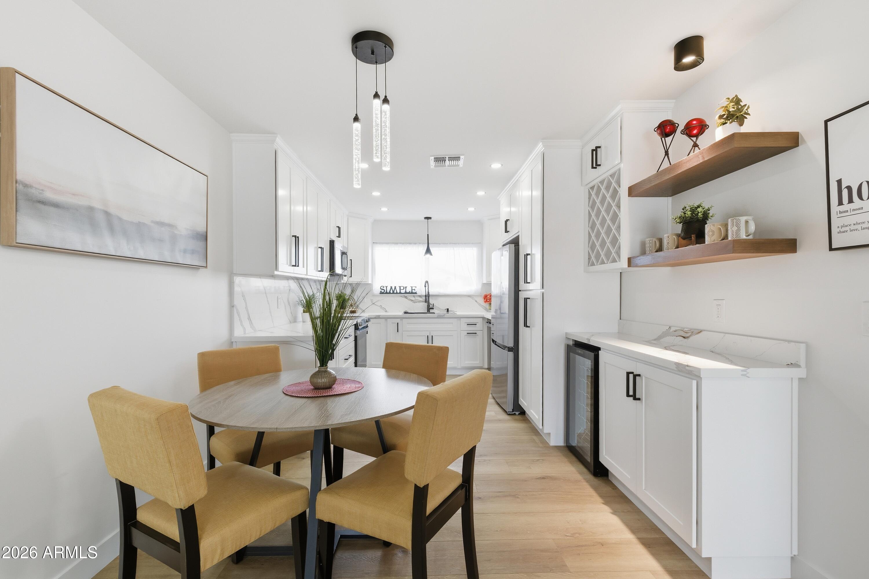 7761 East Chaparral Road Scottsdale, AZ 85250 - Photo 5 of 36 a view of a dining room with furniture and wooden floor