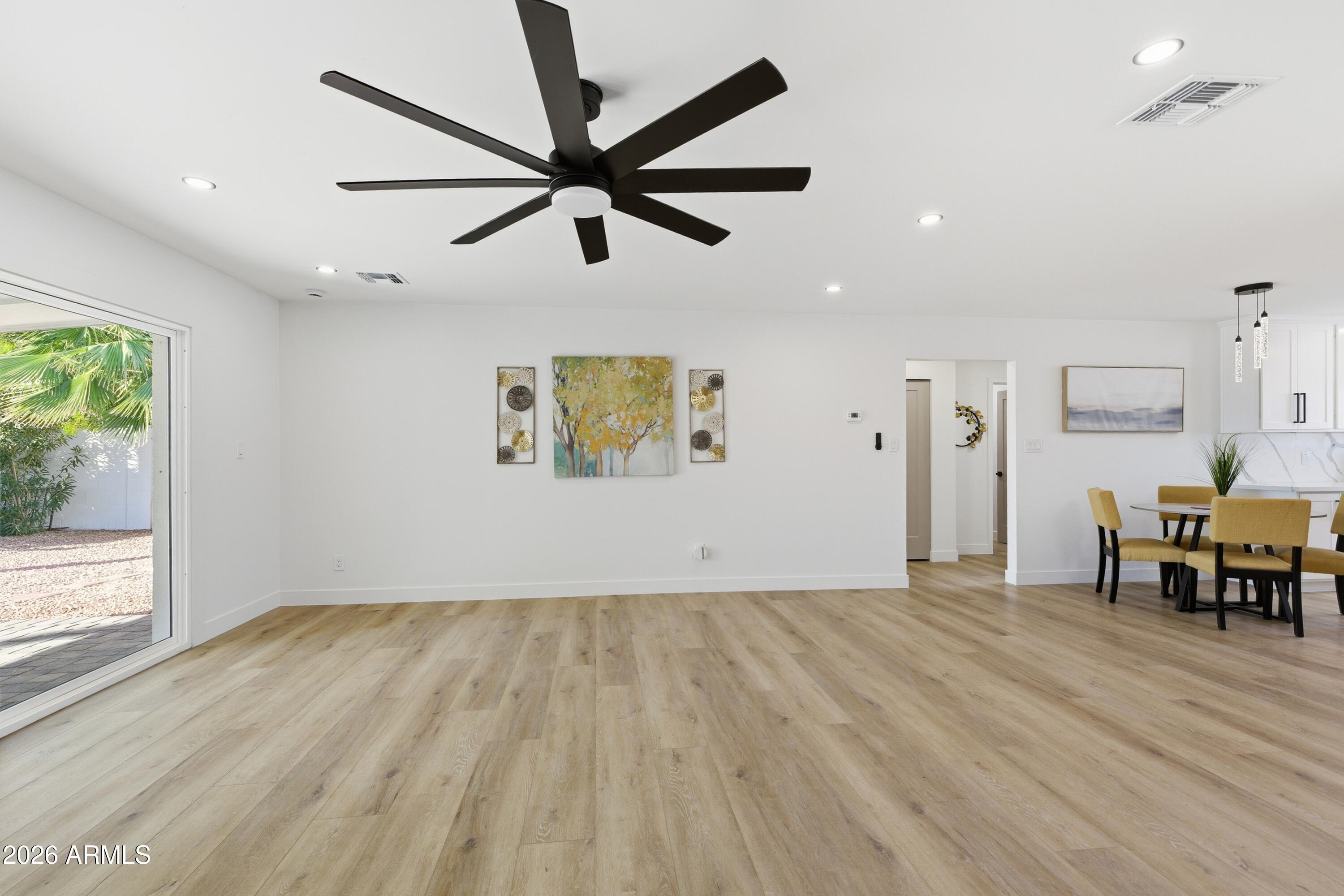 7761 East Chaparral Road Scottsdale, AZ 85250 - Photo 8 of 36 wooden floor in an empty room with a window