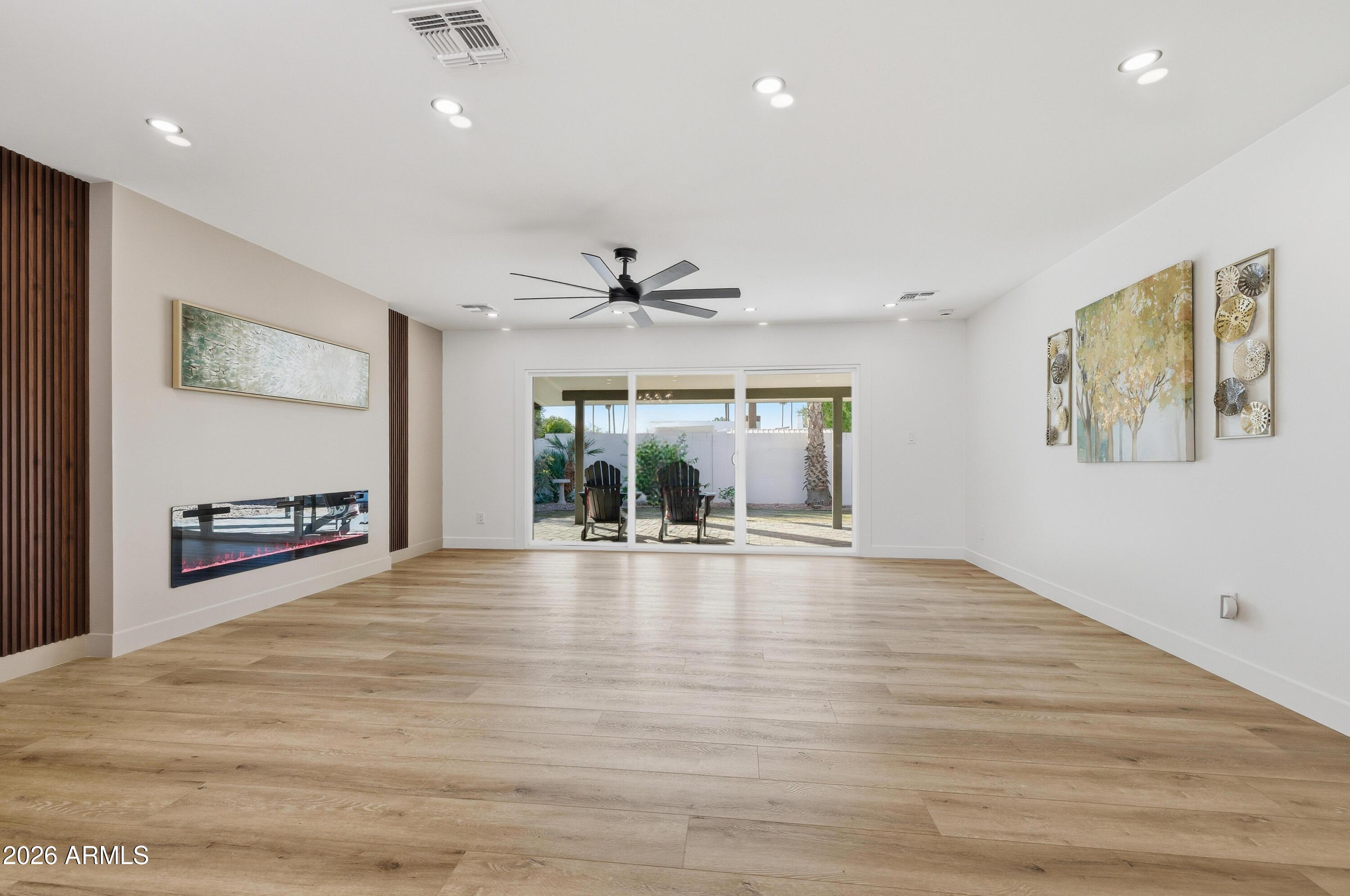 7761 East Chaparral Road Scottsdale, AZ 85250 - Photo 9 of 36 a view of an empty room with window and wooden floor