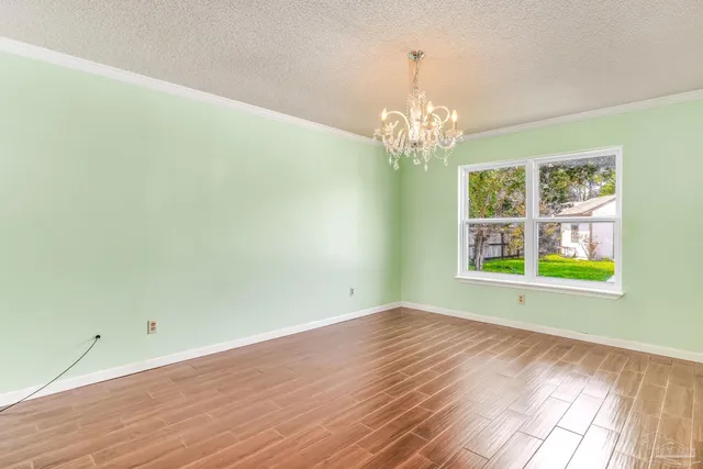 a kitchen with stainless steel appliances granite countertop wooden cabinets a refrigerator a stove a sink and dishwasher with wooden floor