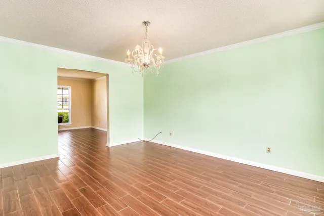 a kitchen with granite countertop wooden cabinets a sink and a window
