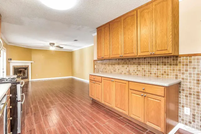 a view of a kitchen with a stove cabinets and wooden floor