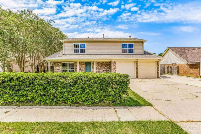 a view of a white house with a large space