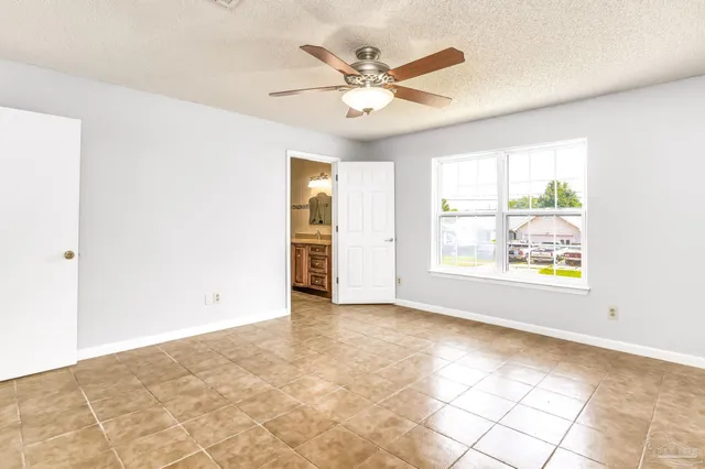 a view of a room with wooden floor and white walls