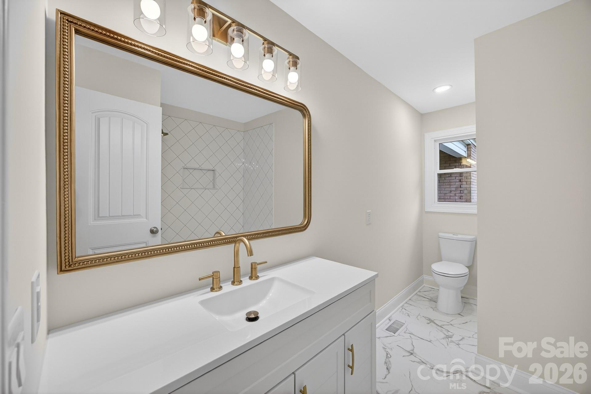 235 Lariat Circle Salisbury, NC 28144 - Photo 13 of 45 a bathroom with a toilet sink and mirror