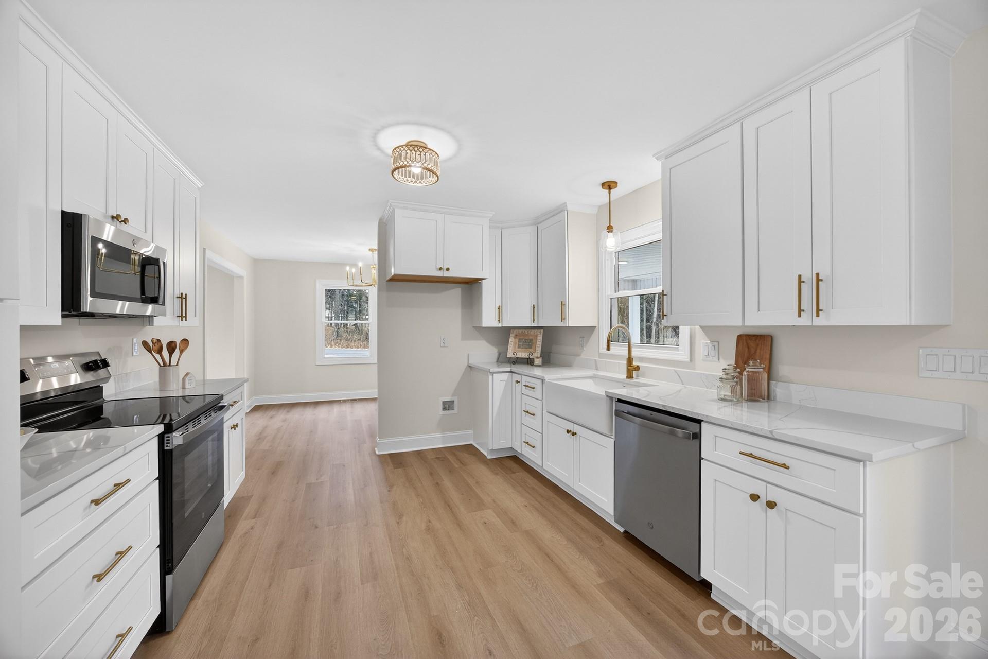 235 Lariat Circle Salisbury, NC 28144 - Photo 17 of 45 a kitchen with cabinets appliances wooden floor and a window
