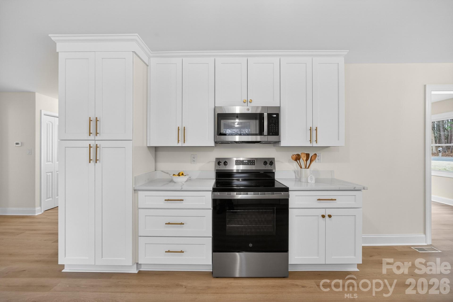 235 Lariat Circle Salisbury, NC 28144 - Photo 19 of 45 a kitchen with white cabinets and stainless steel appliances