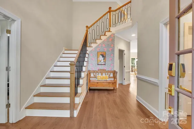 a view of a bedroom with wooden floor and windows