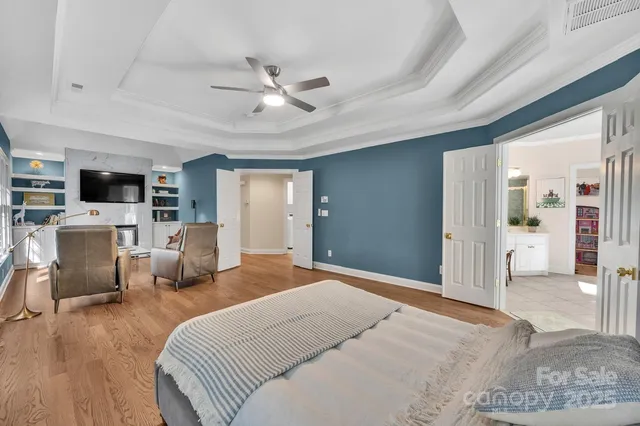 a bathroom with a bathtub shower sink vanity mirror and toilet