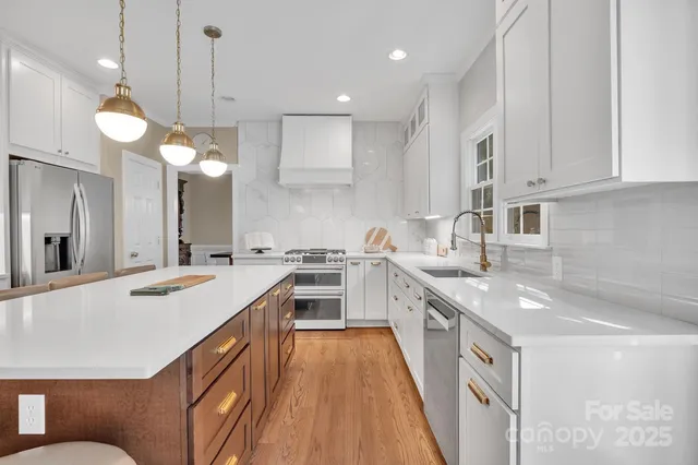 a living room with furniture a fireplace and a floor to ceiling window