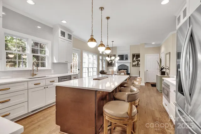 a view of a dining room with furniture a chandelier and wooden floor