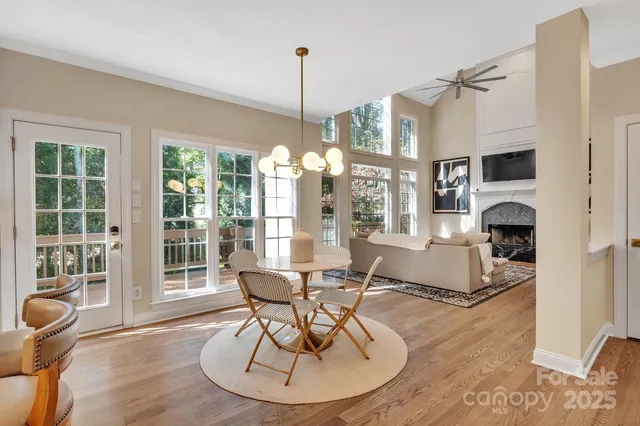 a living room with furniture a rug and a chandelier