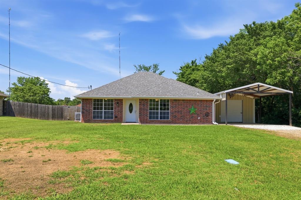 1974 County Road Powderly, TX 75473 - Photo 2 of 28 a front view of a house with garden