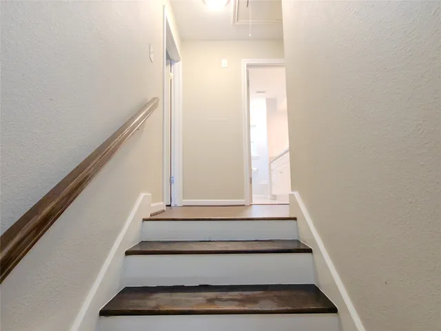 a view of staircase with white walls