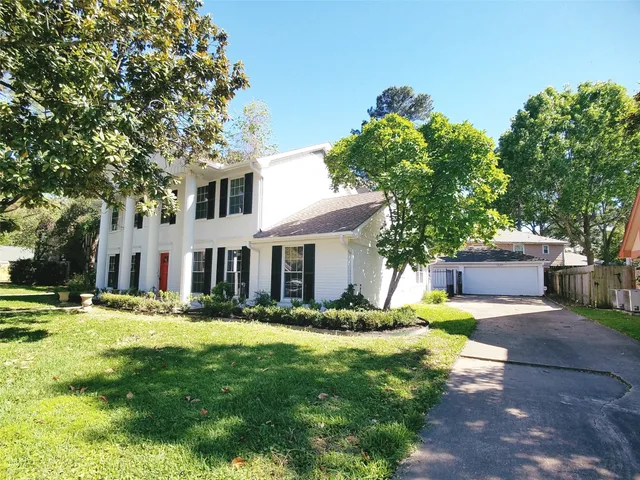 a house view with a sitting space and garden