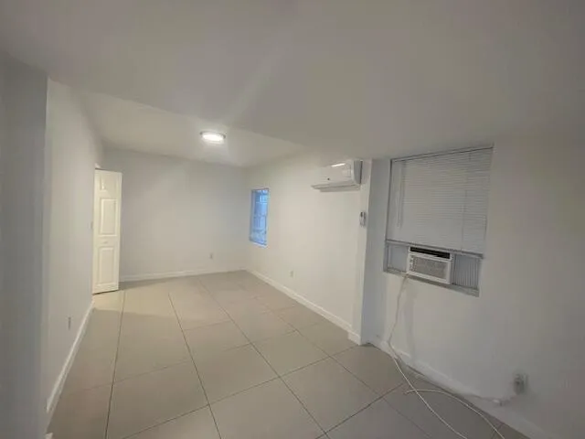 an empty room with a empty space and mirror