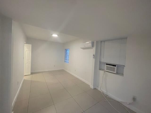 919 2nd Street, Unit 3 West Palm Beach, FL 33401 - Photo 4 of 11 an empty room with a empty space and mirror