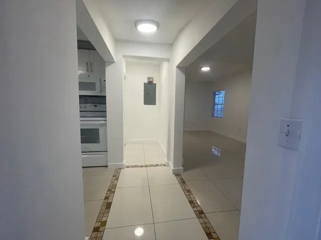 a view of hallway with stairs and a white door
