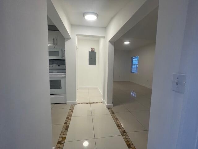 919 2nd Street, Unit 3 West Palm Beach, FL 33401 - Photo 6 of 11 a view of hallway with stairs and a white door