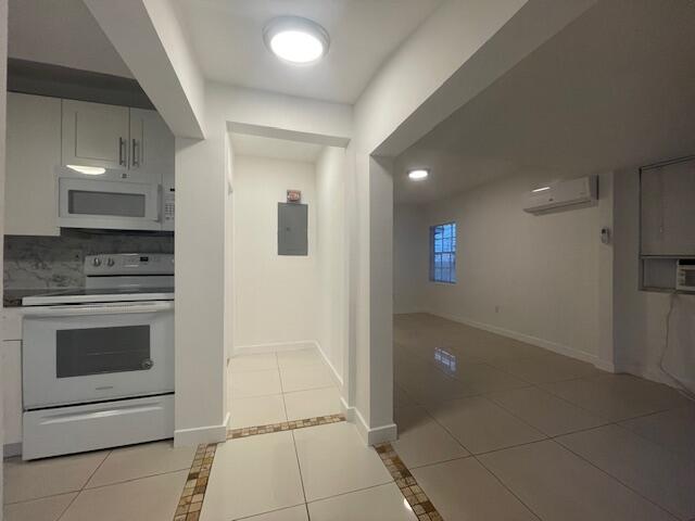 919 2nd Street, Unit 3 West Palm Beach, FL 33401 - Photo 10 of 11 a kitchen with a sink and a stove top oven