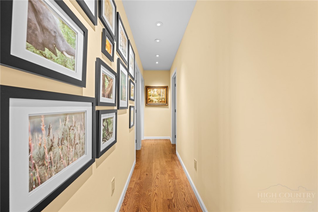 331 Alpine Road Blowing Rock, NC 28605 - Photo 35 of 50 a view of a hallway with wooden floor and staircase