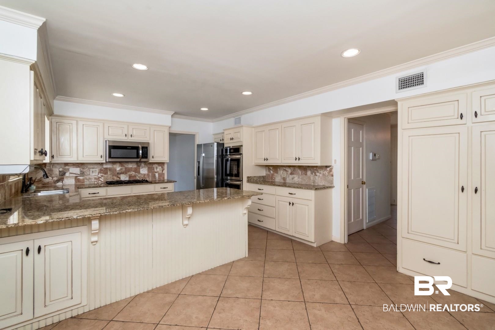 3755 Claridge Road North Mobile, AL 36608 - Photo 5 of 38 Kitchen featuring stainless steel appliances, a sink, crown molding, backsplash, and cream cabinetry