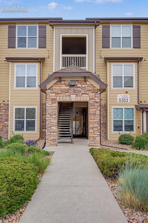 5353 Palomino Ranch Point, Unit 307 Colorado Springs, CO 80922 - Photo 2 of 30 Multi-story building exterior featuring stone veneer accents