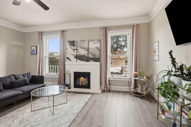 a living room with furniture a flat screen tv and a fireplace
