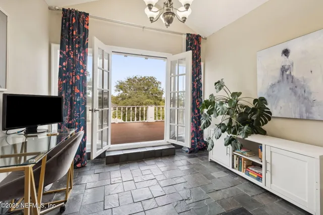a living room with furniture a flat screen tv and a window
