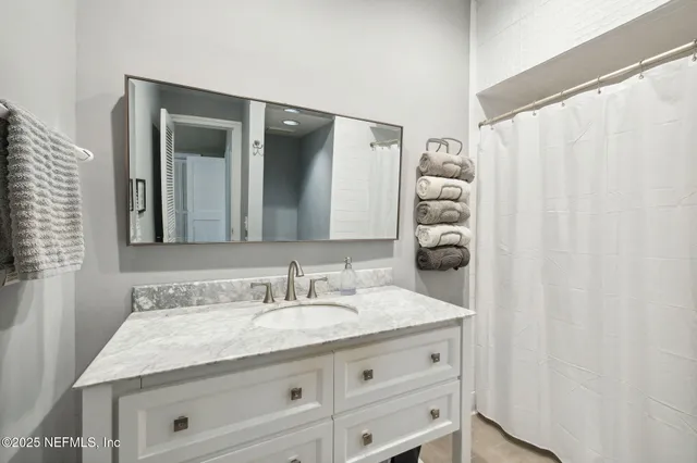 a bed room with a bed and a chandelier