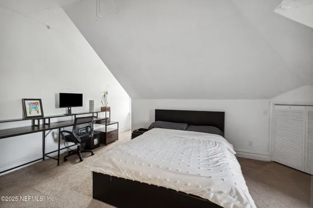 a bedroom with a bed a table and chair