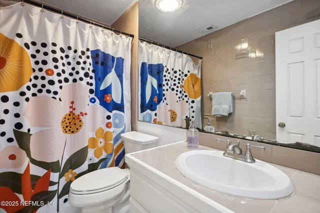 a bedroom with a bed and flat screen tv