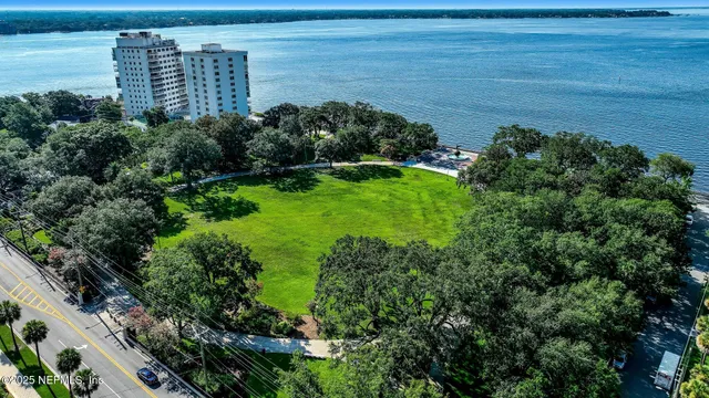 a view of a garden with a building in the background