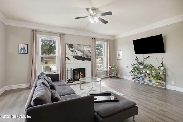 a living room with furniture a flat screen tv and a fireplace