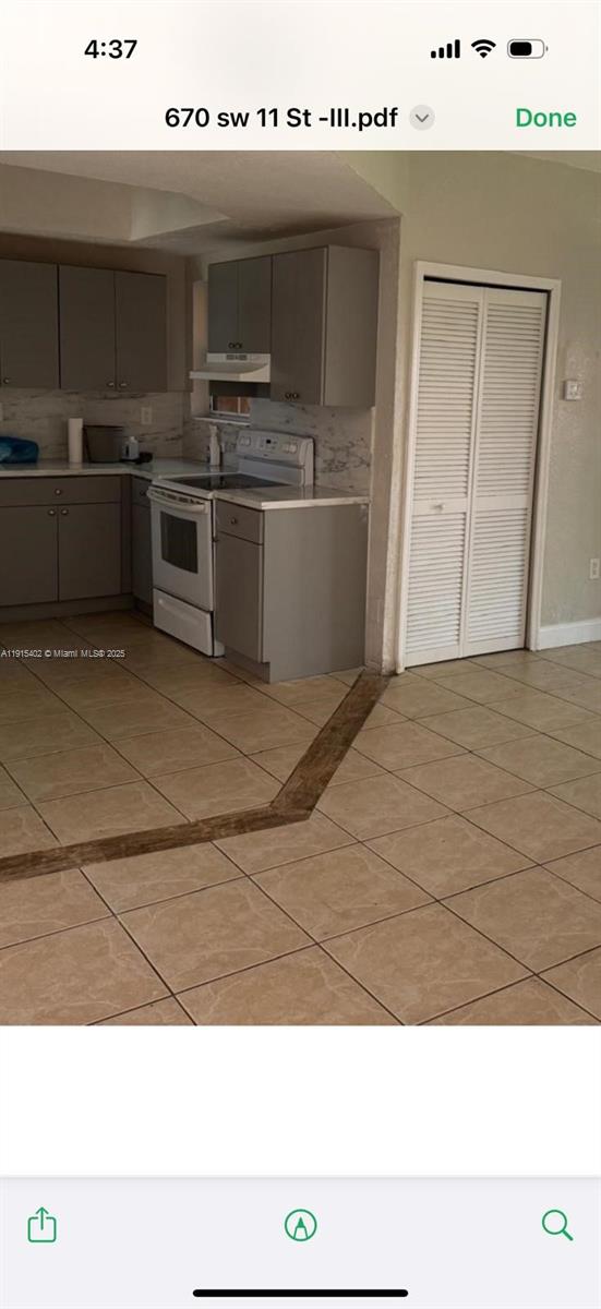 657 Southwest 10th Street, Unit 657 Florida City, FL 33034 - Photo 4 of 12 a kitchen with kitchen island stainless steel appliances a sink and stove
