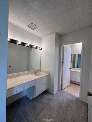 a bathroom with a tub sink shower and mirror