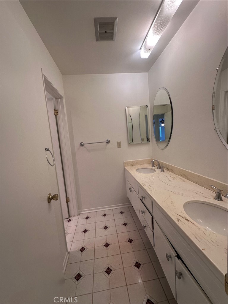 20631 Romar Street Chatsworth, CA 91311 - Photo 25 of 34 a spacious bathroom with a sink mirror vanity and toilet