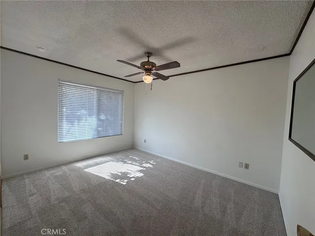a view of a livingroom with a ceiling fan and window