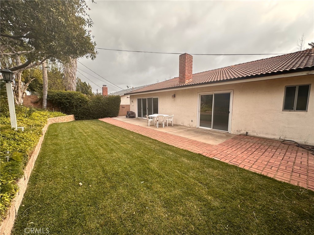 20631 Romar Street Chatsworth, CA 91311 - Photo 33 of 34 a front view of a house with a yard
