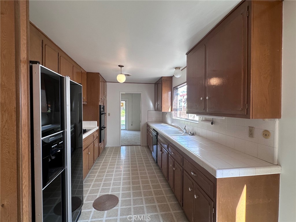 20631 Romar Street Chatsworth, CA 91311 - Photo 4 of 34 a bathroom with a double vanity sink a toilet and a mirror